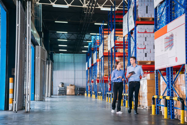 istock Warehouse worker working and checking the stock in the warehouse. Factory manager using digital tablet check barcode in industry factory logistic. 1821883022