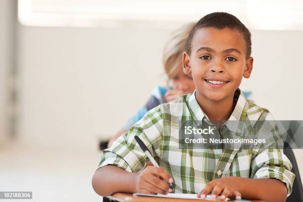 African American School Boy Making Notes Stock Photo - Download Image Now - Boys, Writing - Activity, 6-7 Years