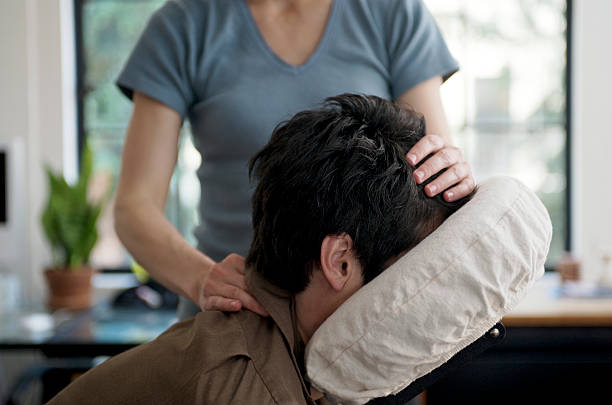 Man Getting Mobile Chair Massage in an Office stock photo