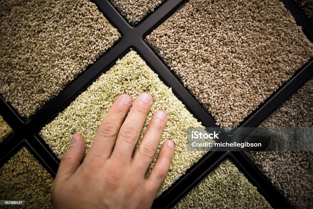 Close-up of man's hand feeling carpet samples Man touches a sample of carpet Carpet Sample Stock Photo