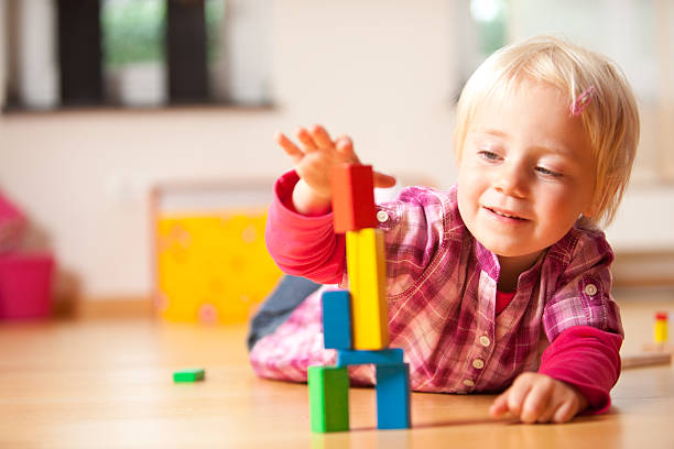 istock happy girl is playing with blocks 182188458
