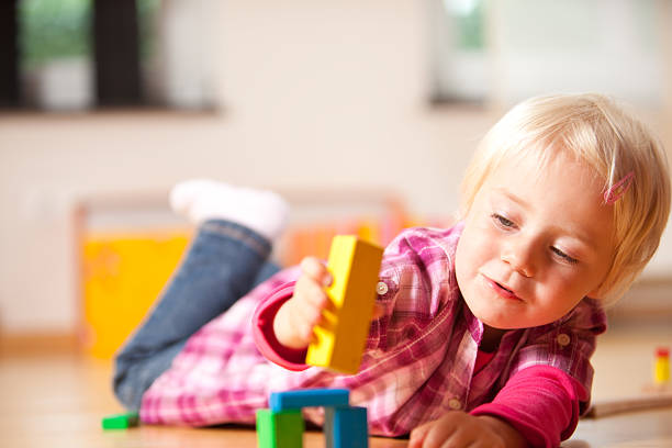 istock happy girl is playing with blocks 182188463