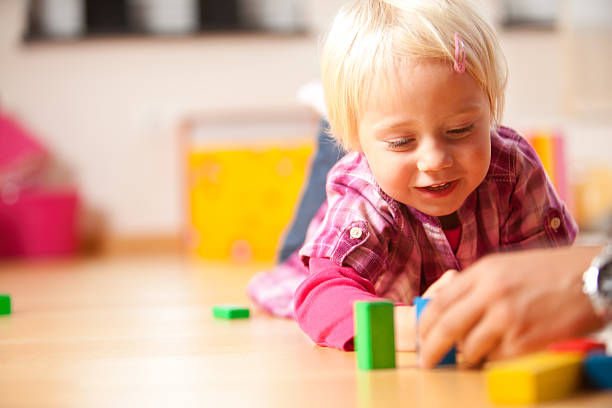 istock happy girl is playing with blocks 182188473