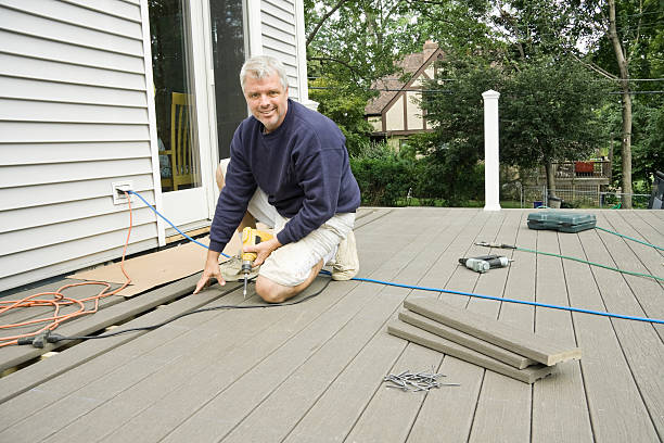 carpenter building a deck in the suburbs stock photo