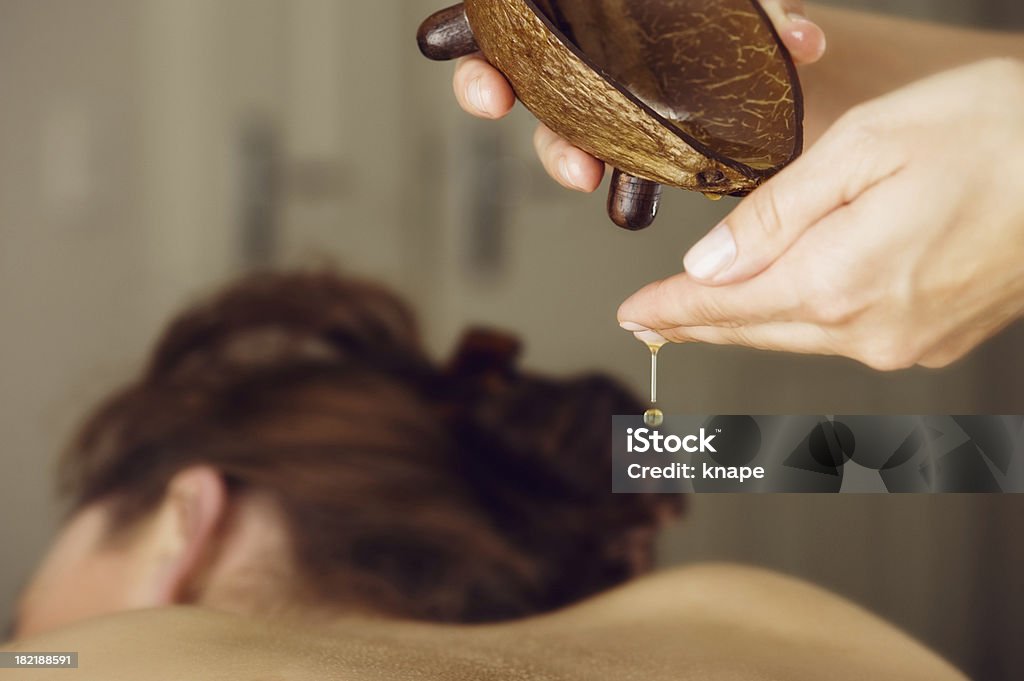 Woman at spa on a massage table Woman at a spa on a massage table Massage Oil Stock Photo