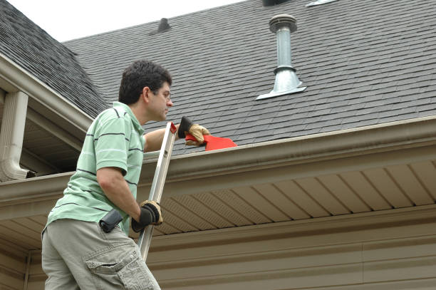 istock Man on a Ladder Cleaning Leaves from Gutter 182188658