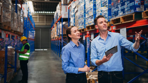 istock Warehouse worker working and checking the stock in the warehouse. Factory manager using digital tablet check barcode in industry factory logistic. 1821886823