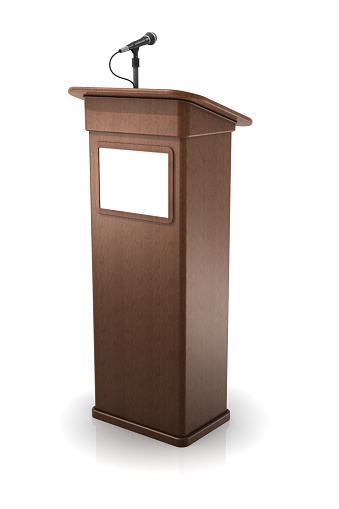 Wooden podium with microphone and sign on a white background.