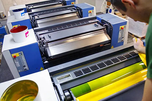 The printer distributes the ink in the printing press. Offset printer in Printing Plant. Printing and printing machines.