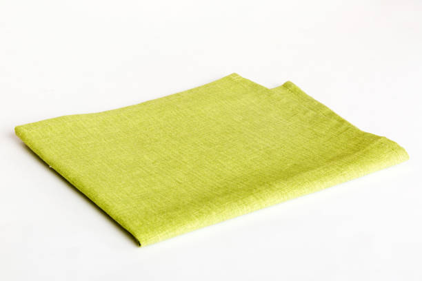 istock top view with green kitchen napkin isolated on table background. Folded cloth for mockup with copy space, Flat lay. Minimal style 1821889054