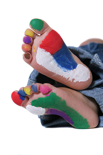 Happy child with painted feet stock photo
