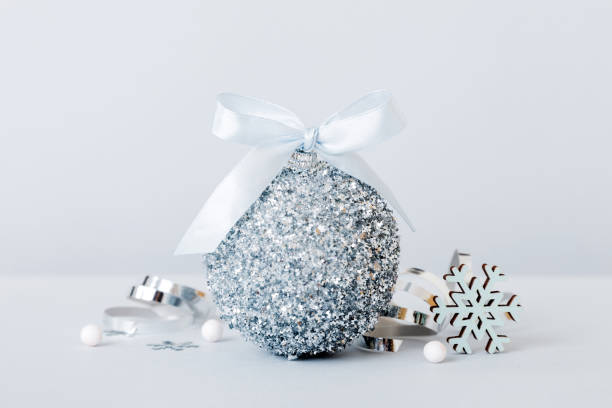 istock Christmas ball on colored background. decoration bauble with ribbon bow with copy space 1821889578