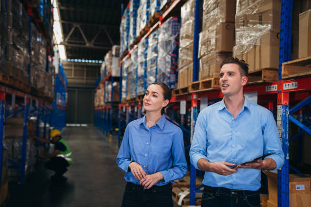 istock Warehouse worker working and checking the stock in the warehouse. Factory manager using digital tablet check barcode in industry factory logistic. 1821896066