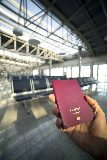 istock holding passport in airport 182190170