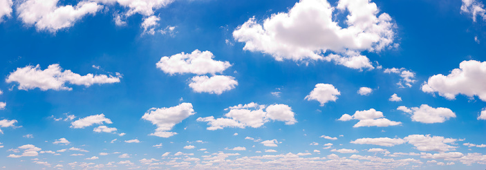 Blue sky with white fluffy cumulus clouds