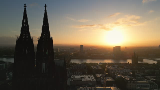 Aerial view Real time Footage flying though Cologne cathedral and Hohenzollern Bridge at sunrise time in Downtown of Cologne, Germany,