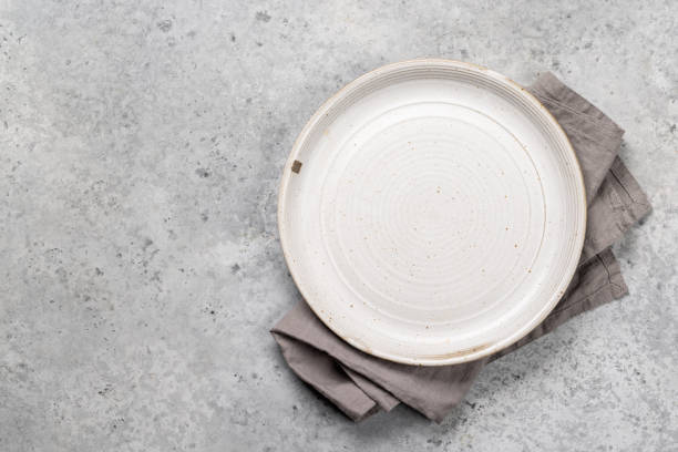 istock Mockup for a delicious meal. Empty plate on a table 1821909326