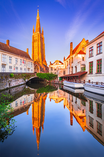 Bruges, Belgium. Church of Our Lady, Vrouwekerk, water reflection. Medieval Brugge, West Flanders.