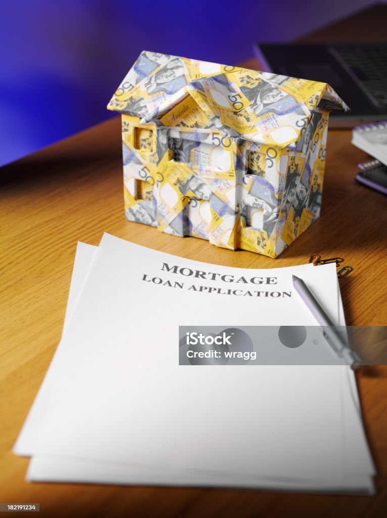 House made from Australian Dollars in a Office House made of Australian dollars on a desk in a office, Copy space Australian Currency Stock Photo