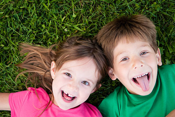 istock Happy Boy and Girl Lying in the Grass 182191683