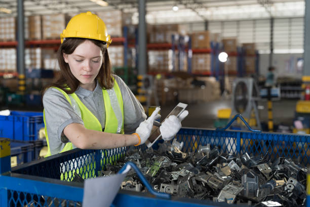 istock Warehouse and manufacturing concept. Female warehouse worker working with tablet and inspecting quality for auto spare parts at warehouse 1821930078