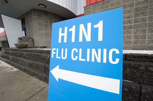 Signs showing entrance to an H1N1 flu shot clinic.  Click to view similar images.