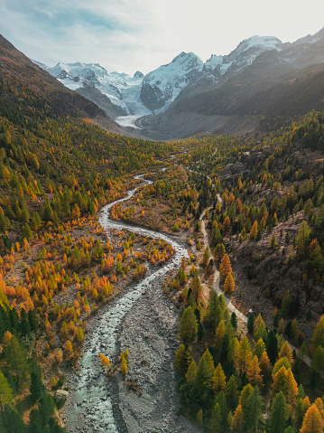 Idyllic aerial view of glacier and  river in Swiss Alps in autumn