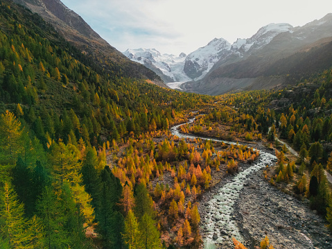 Idyllic aerial view of glacier and  river in Swiss Alps in autumn