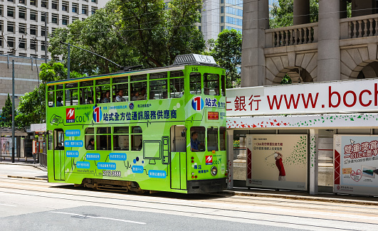 Central, Hong Kong - July 21, 2009 : Double decker tram picking up passengers. Electric tram making a brief stop on its way to North Point on Hong Kong Island.