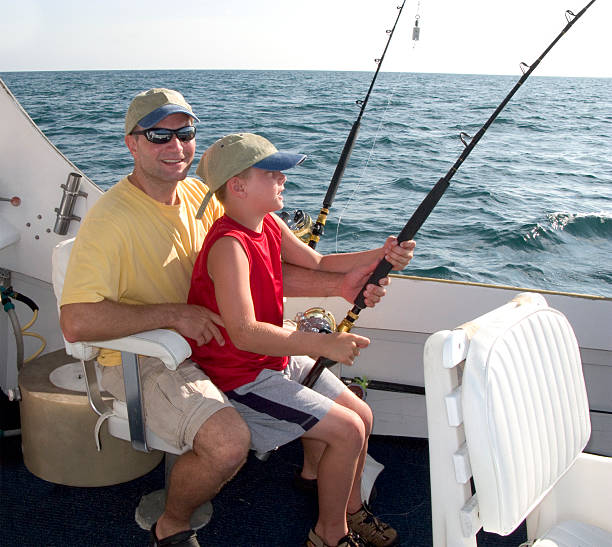 Father & Son (boy) On Charter Fishing Boat stock photo