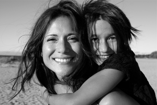 A portrait of a beautiful mom and her eight year old daughter having fun together at the beach. Please view many other family portraits in my portfolio.