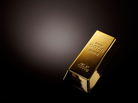 A bar of gold bullion on  a black background with copy space.Click on the links below to see more of my business and objects images.