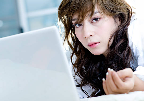 Young happy woman using laptop in the living room.