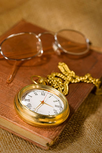 istock Old book, glasses and golden pocket watch 182197798
