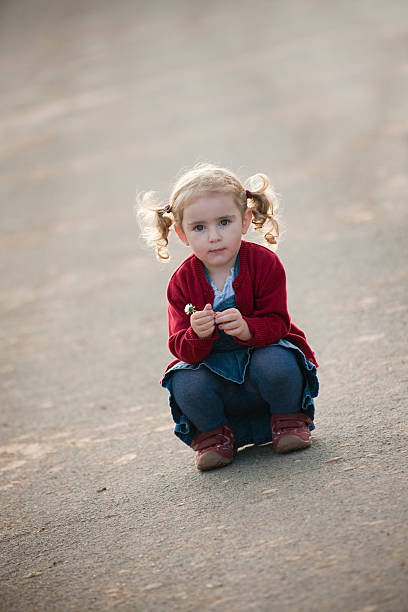 istock Little girl with flower 182197990