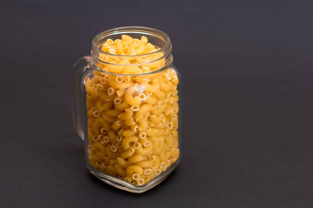 istock Uncooked Chifferi Rigati Pasta in Glass Jar on Black Background 1821981096