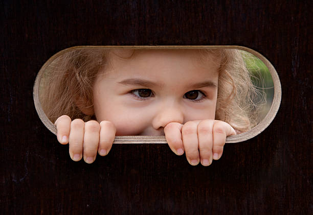 istock Peek-a-boo! Little girl looking out 182198412