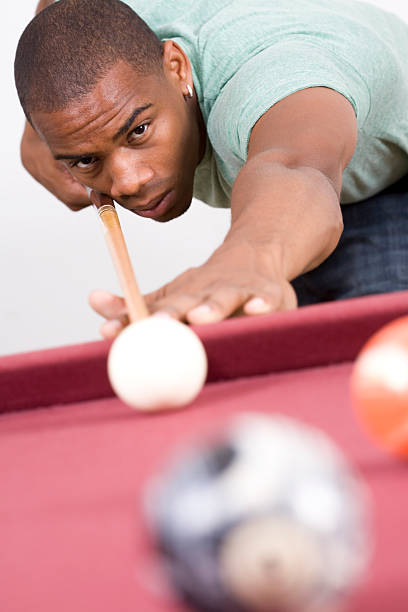 istock Young Man lining to hit eight ball on pool table 182199117