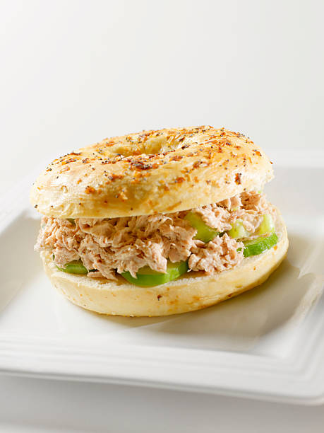 insalata di tonno in un bagel multigrain - tuna tuna salad bagel sandwich foto e immagini stock