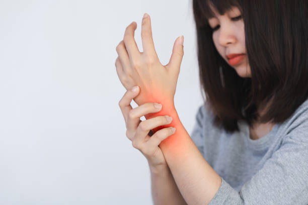 istock Women's wrist pain from using the hands to work repetitively for a long time or from general diseases of the body such as diabetes, thyroid gland, tumors around the wrist. 1821993996