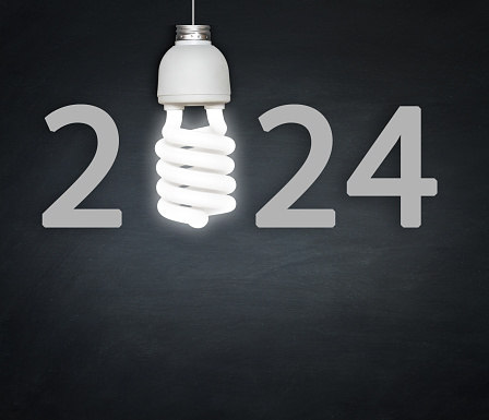 New year 202text with light bulb on blackboard