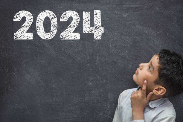 2024 Happy new year school class academic calendar with student kid's hand drawing greeting on teacher's chalkboard