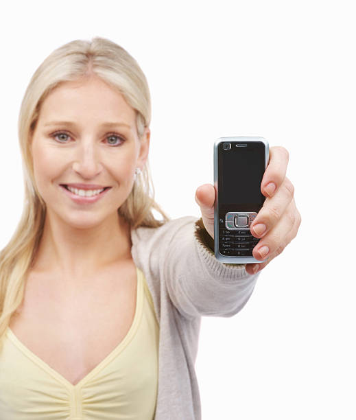 istock Smiling young lady holding a cellphone 182199631