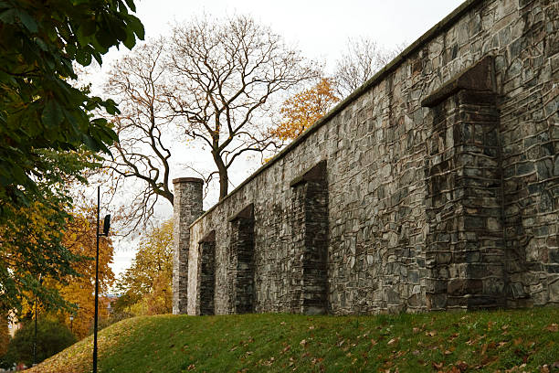 Stone wall  of a prison. "Stone wall  of a prison in fall.  Oslo, Norway." norway autumn oslo tree stock pictures, royalty-free photos & images