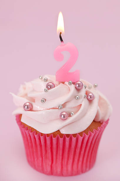 istock Pink cupcake with a number 2 candle. 182200102