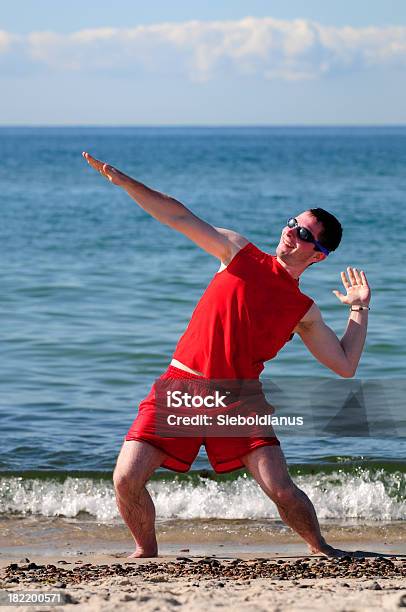 Surfer Dude Exercising On The Beach In Red Swim Suit Stock Photo - Download Image Now