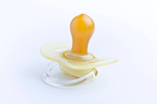 Yellow dummy / pacifier on white stock photo