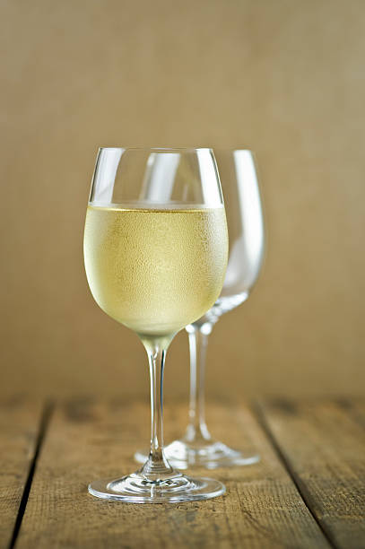Glasses of white wine on wood table stock photo