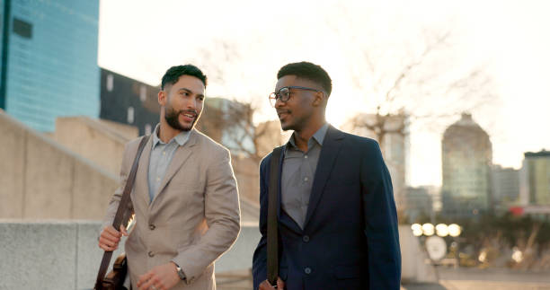 istock Businessmen, morning sunrise and walking to work while talking, strategy idea and business investment. Discussion, city buildings and colleagues commute together to plan, startup company and idea 1822010585