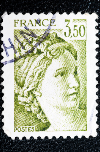Greek postage stamp isolated on black